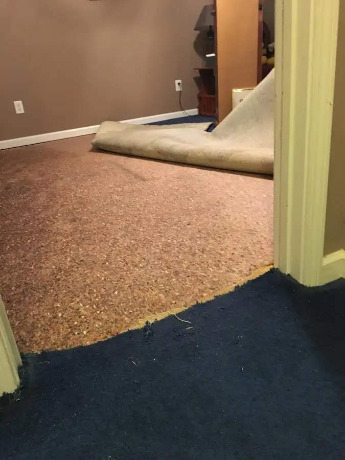 Carpet pad removal revealing water damage during Water Mitigation Services in Menifee